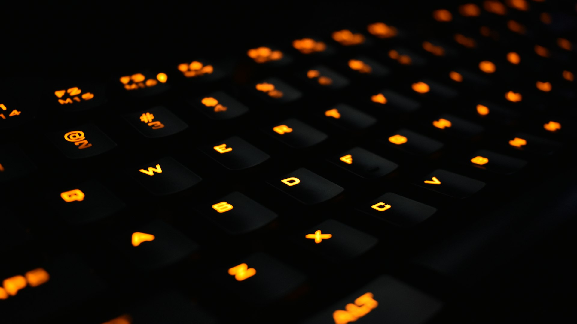 Players at gaming stations inside the TapGameFlow arena at night